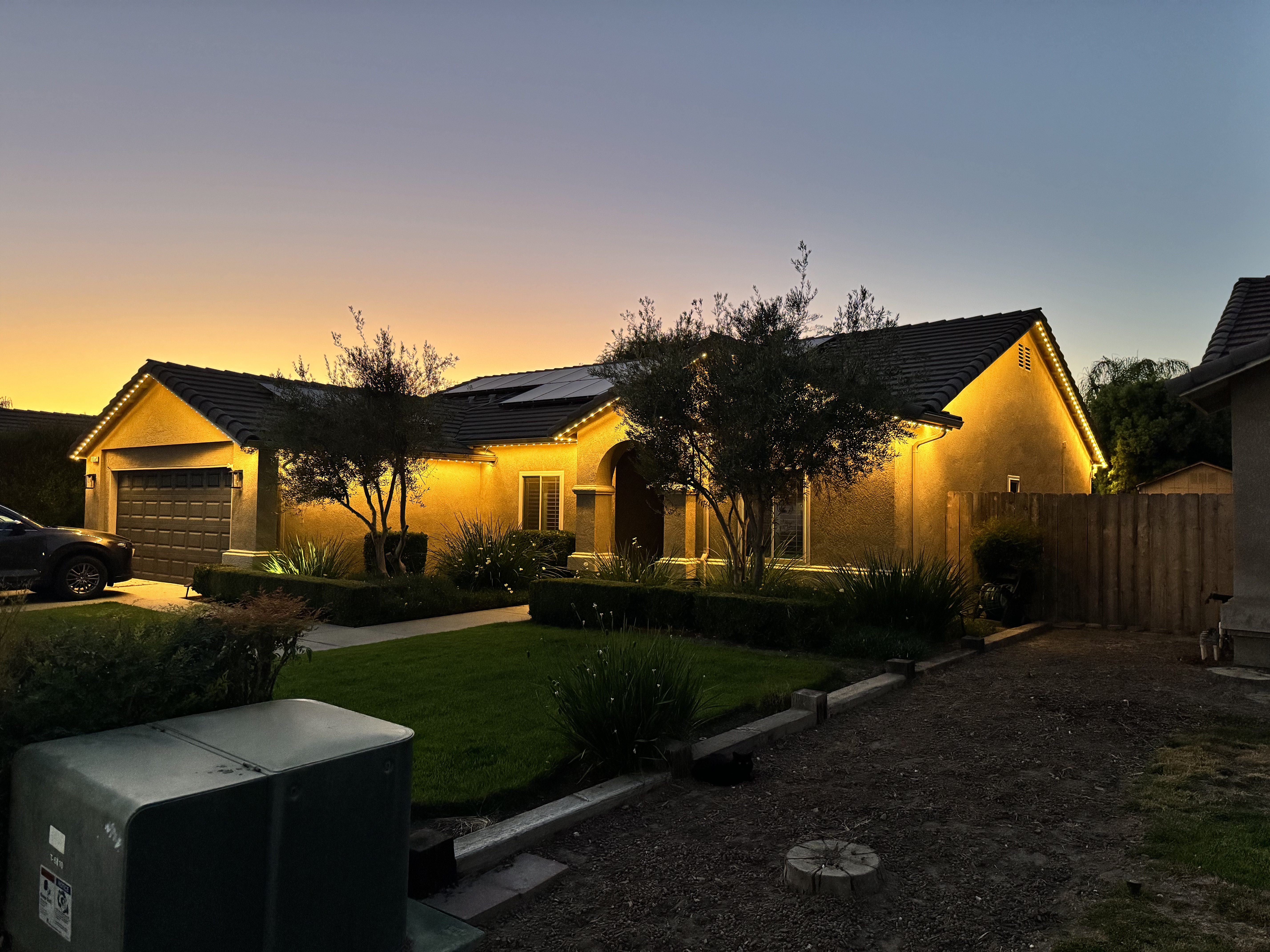 Wide view of EverLume permanent roofline lighting at dusk