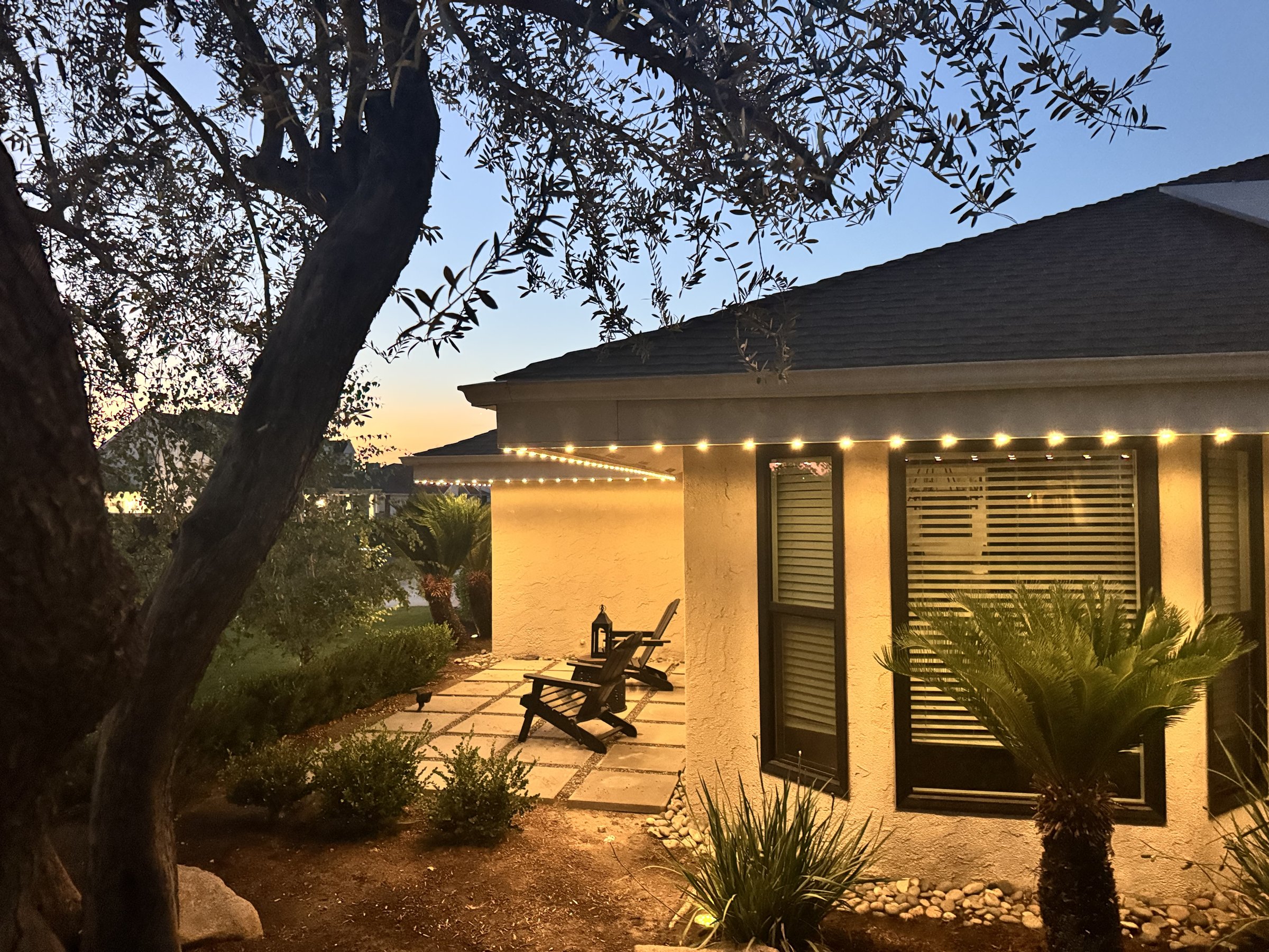 Window nook and landscaping lit by EverLume permanent lighting