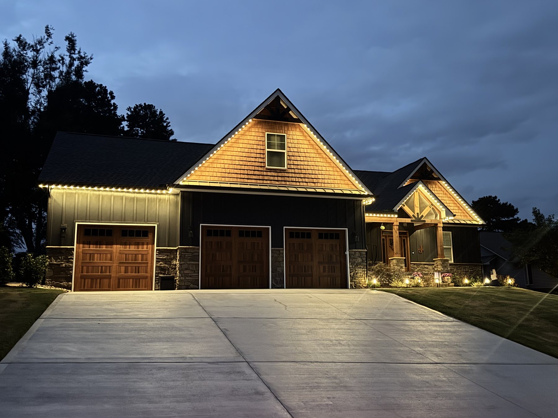 EverLume permanent architectural lighting installed along a roofline at dusk